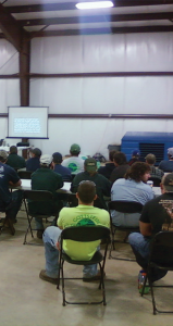 A diverse team discussing safety protocols, with a focus on leadership and employee empowerment.